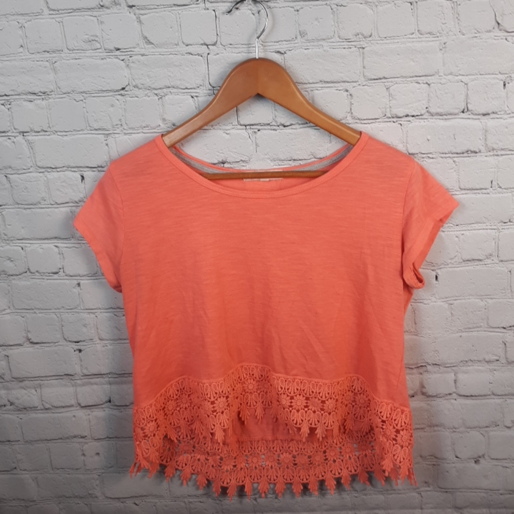 A pinkish orange crop top